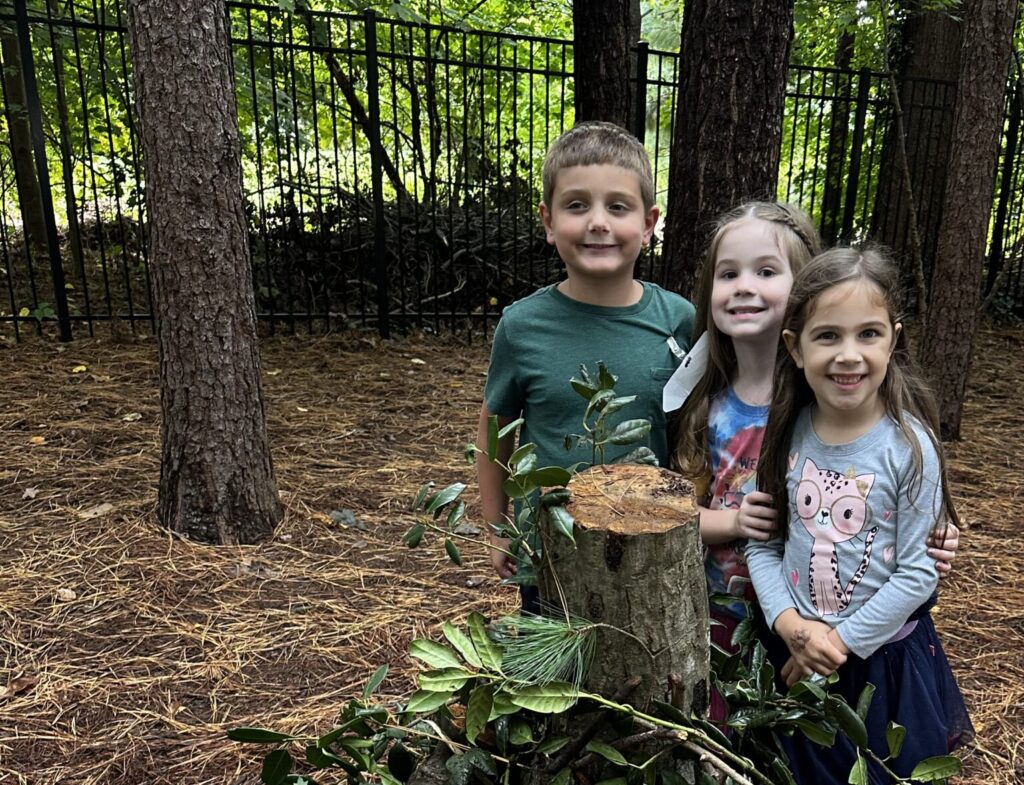 Children exploring nature at Woodlawn School during an admission event.
