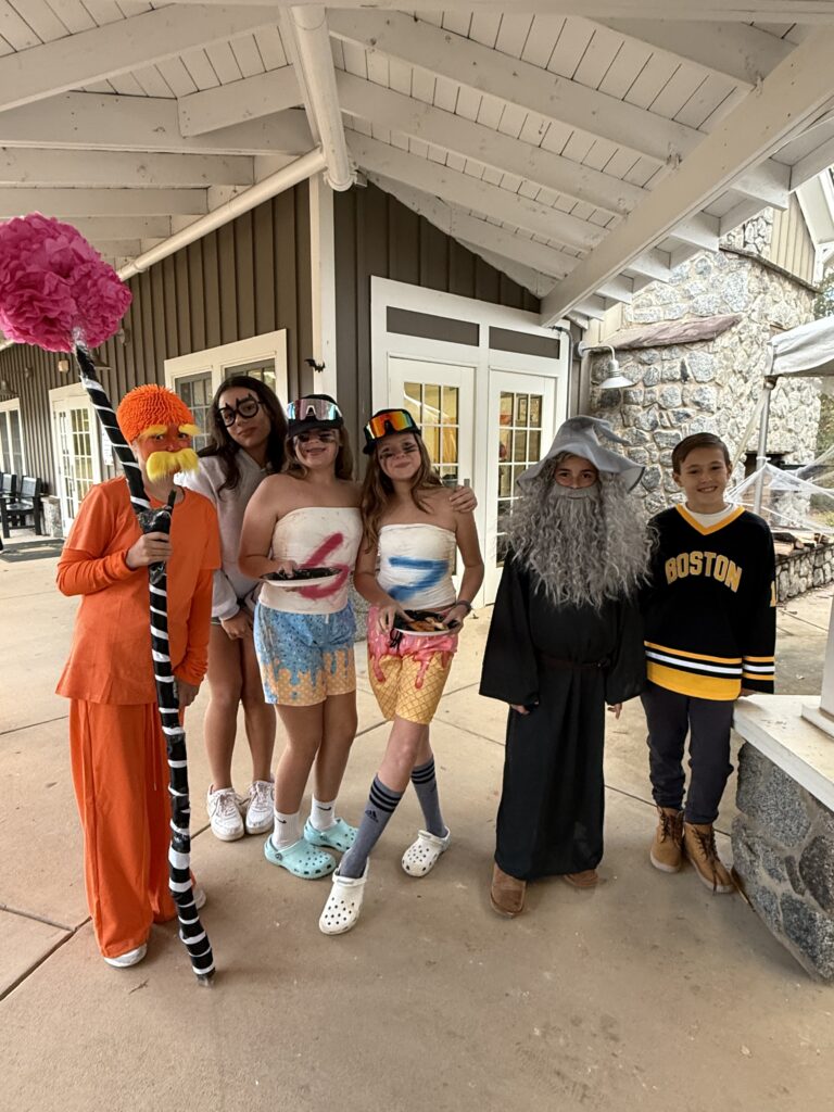 Students in colorful costumes at Woodlawn School during costume day event.