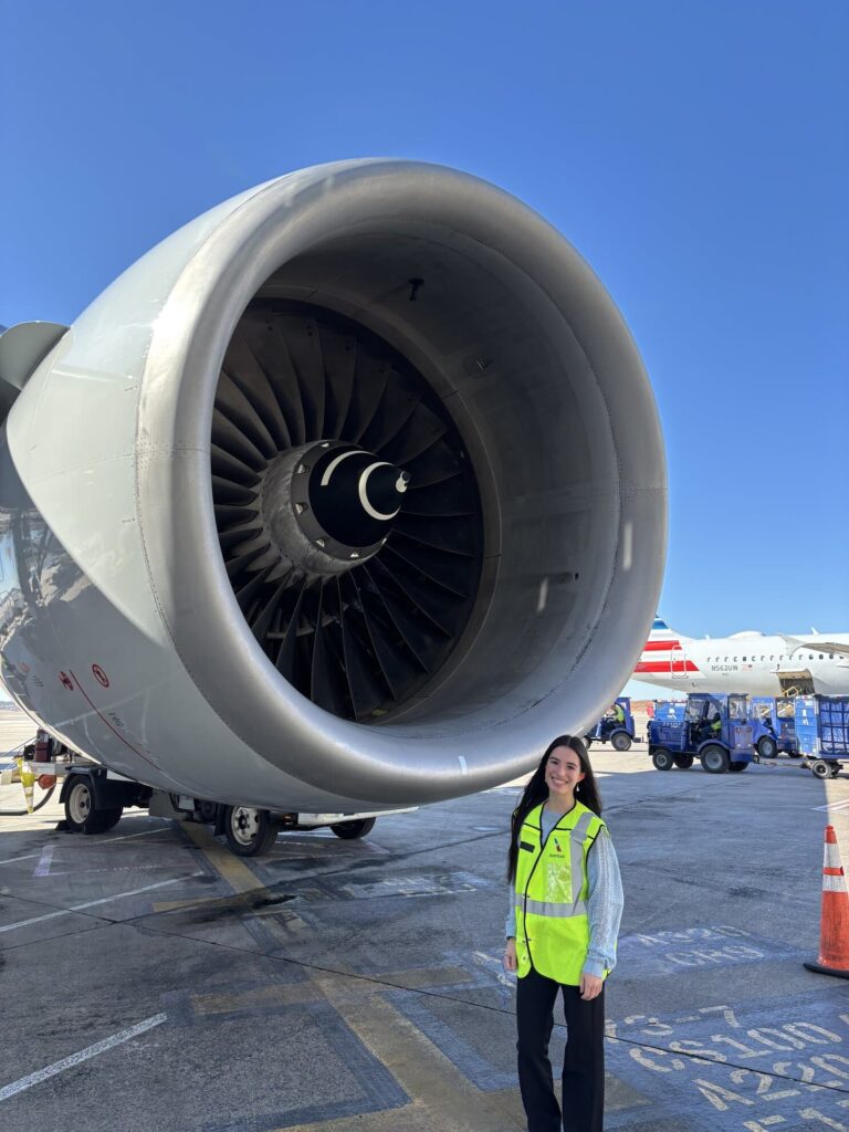 A ’Blazer in a safety vest beside an airliner’s jet engine